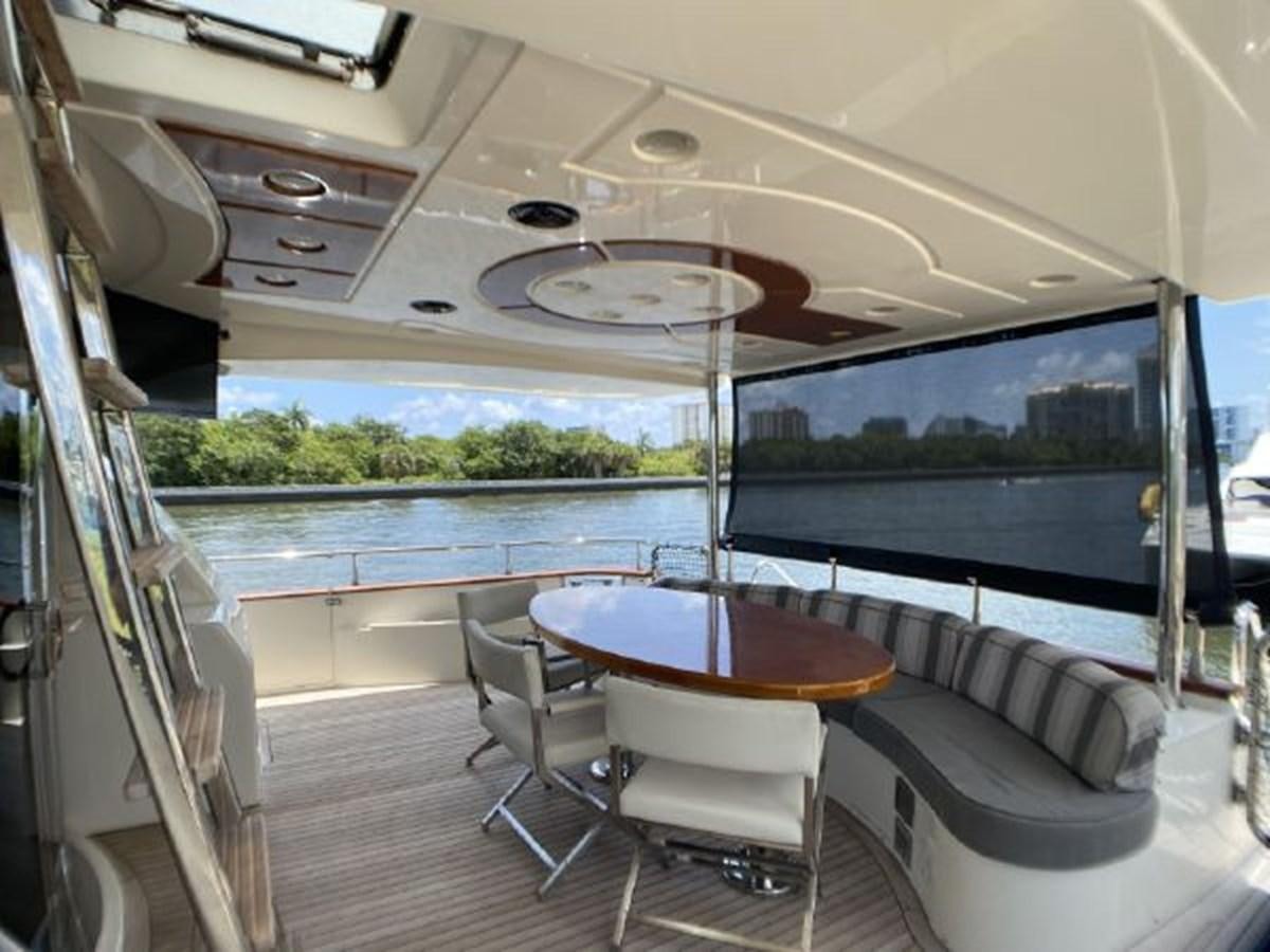 a boat with a table and chairs aboard 85 AZIMUT ULTIMATE Yacht for Sale