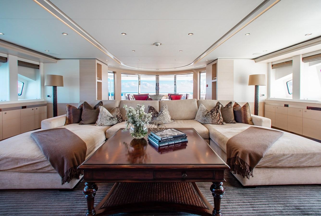 a large living room with a large window aboard LADY L Yacht for Charter