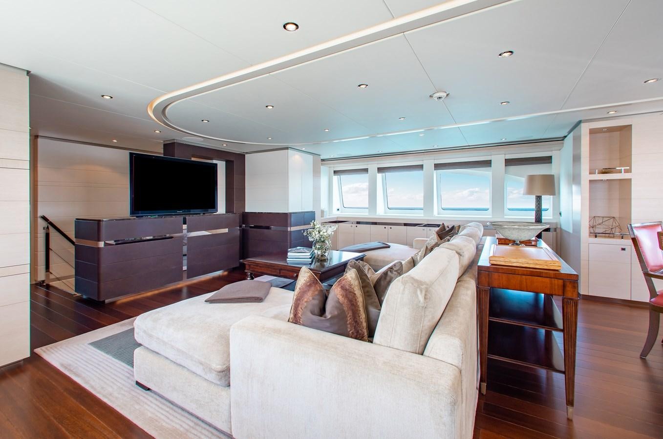 a living room with a large screen aboard LADY L Yacht for Charter