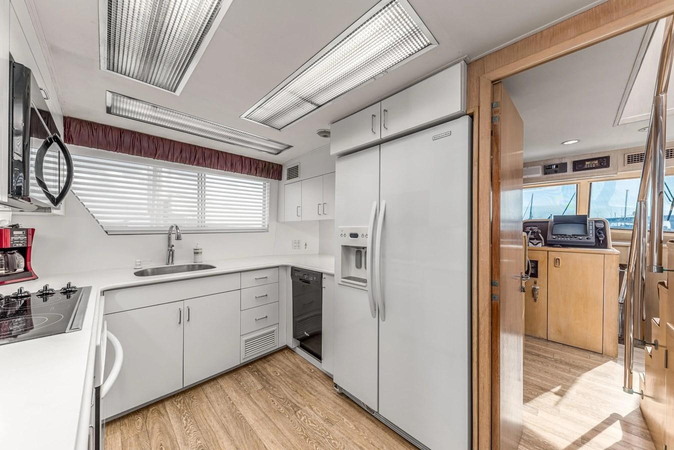 a kitchen with white cabinets aboard KALEVALA Yacht for Sale