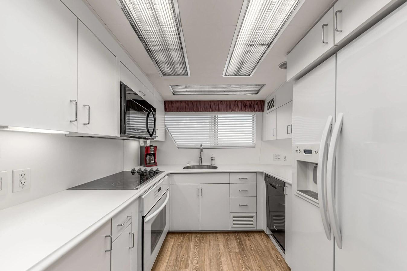 a kitchen with white cabinets aboard KALEVALA Yacht for Sale