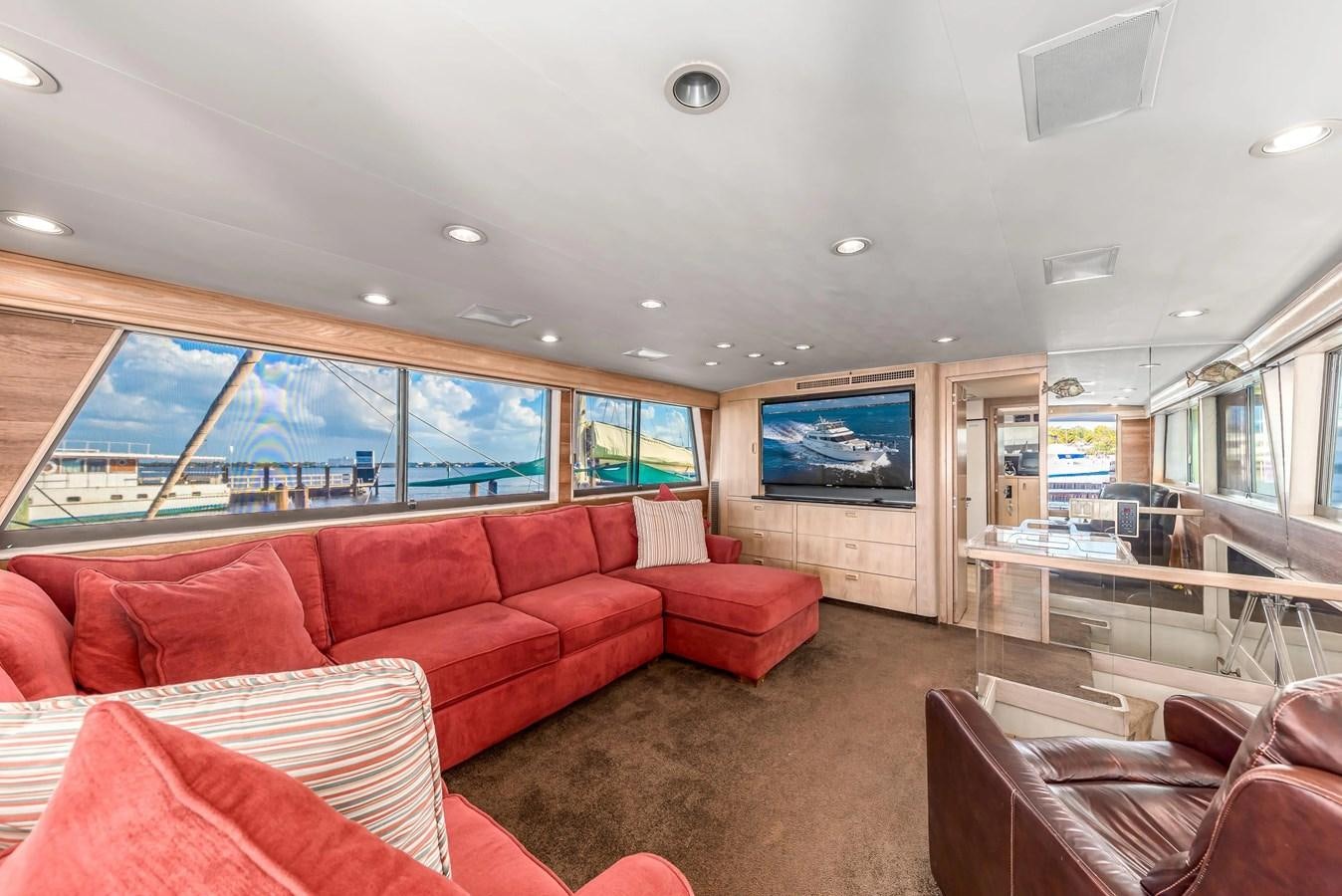 a living room with a large screen aboard KALEVALA Yacht for Sale