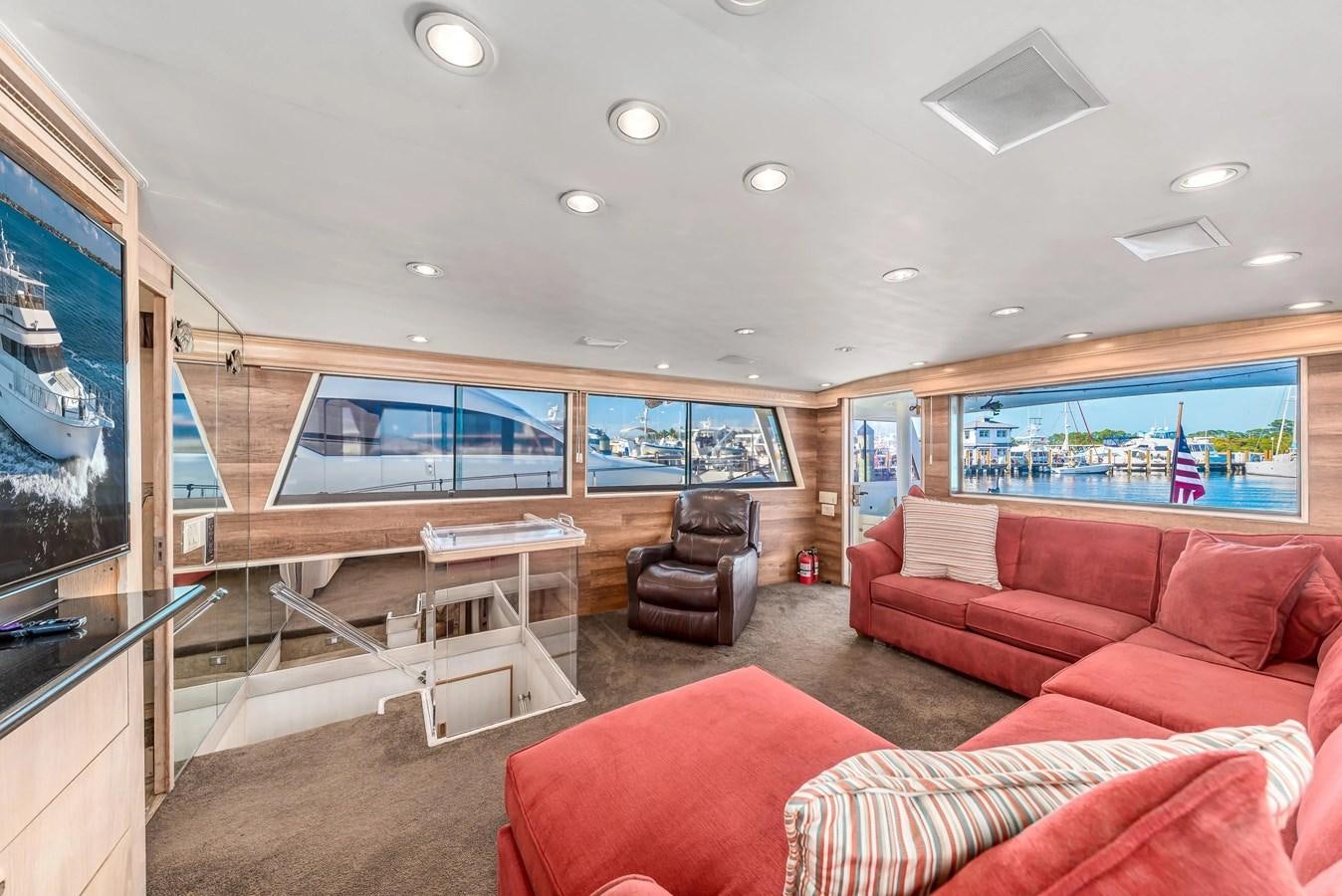 a living room with a large screen aboard KALEVALA Yacht for Sale