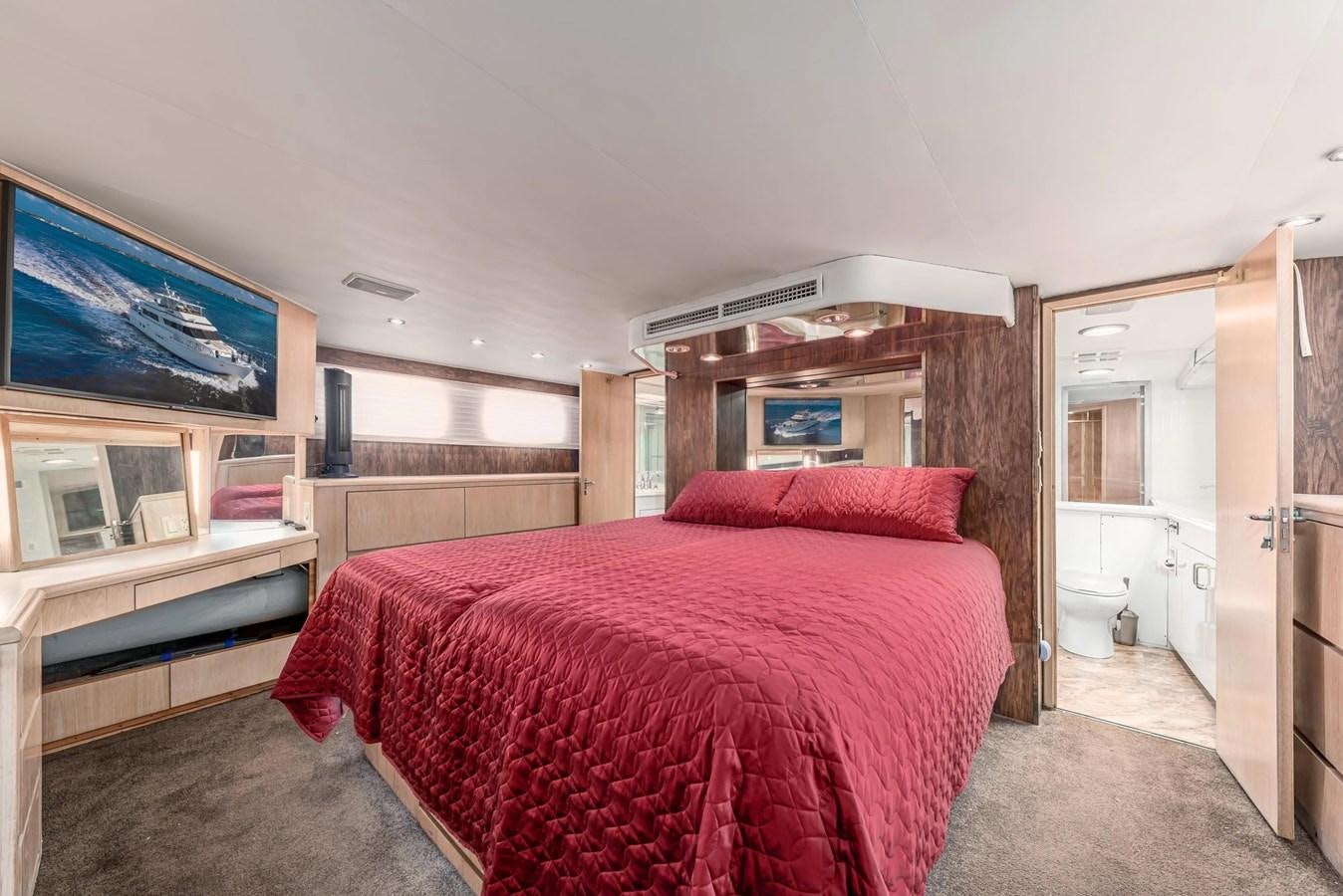 a bedroom with a bed and a desk aboard KALEVALA Yacht for Sale
