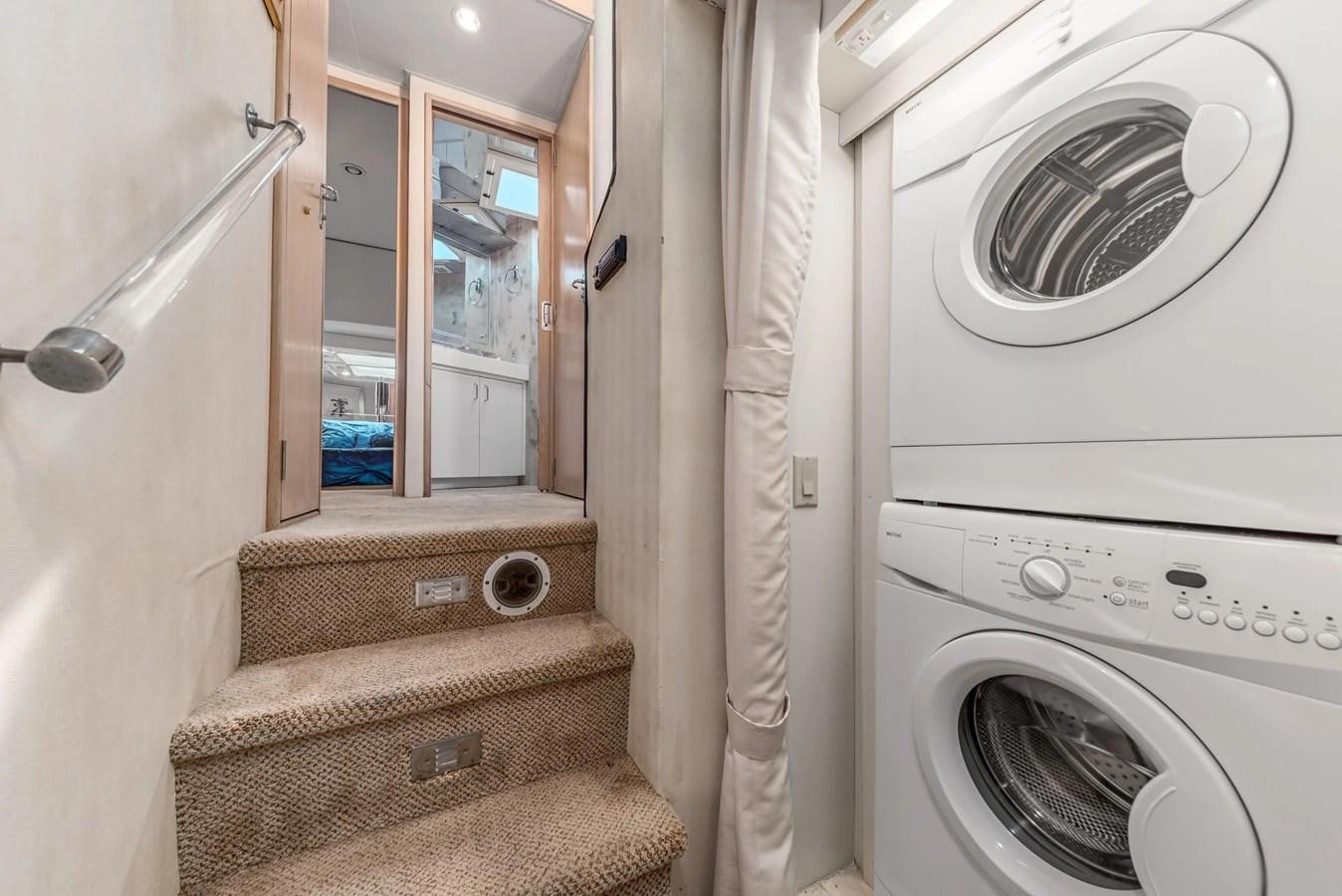 a room with a washing machine and a mirror aboard KALEVALA Yacht for Sale