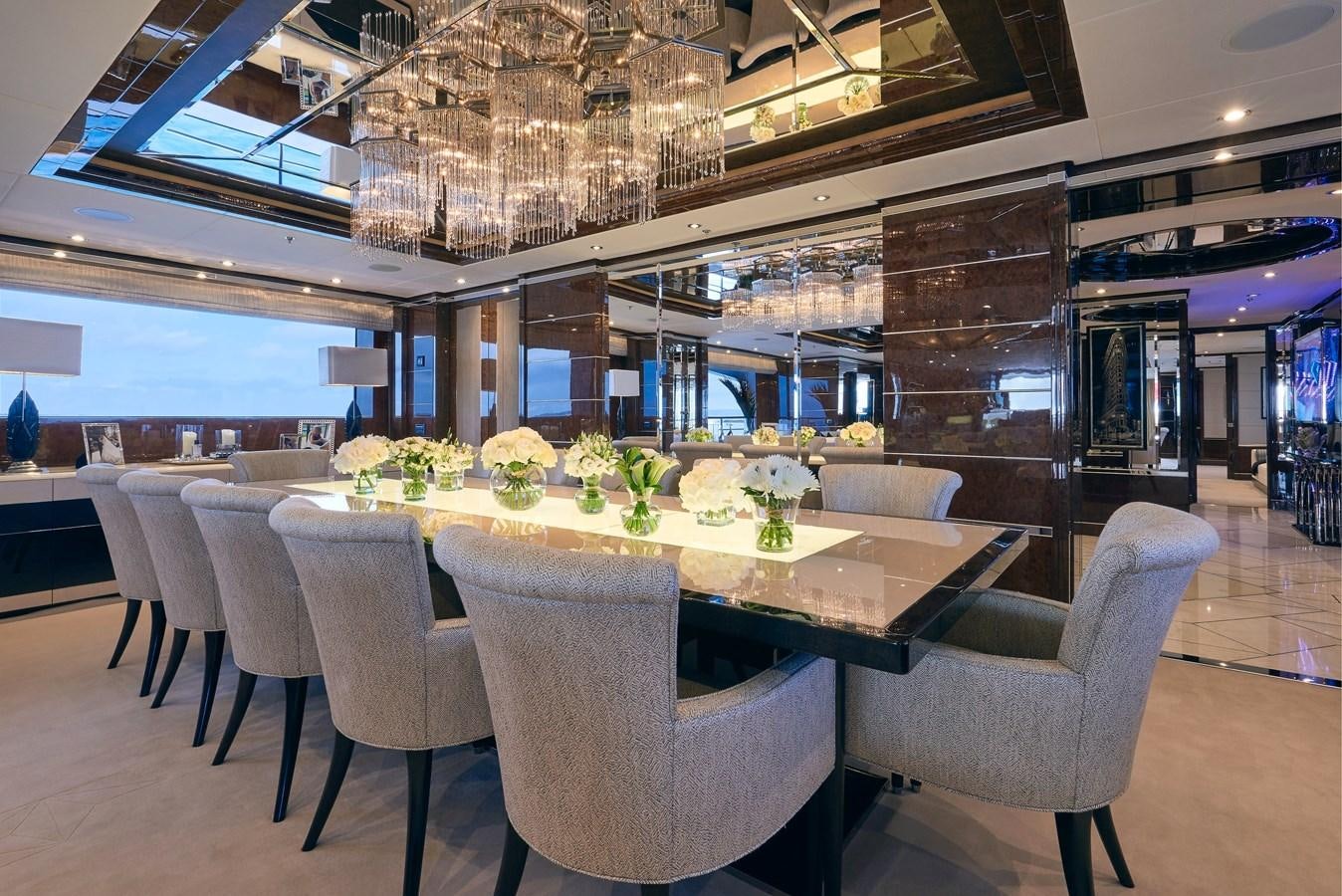 a room with tables and chairs aboard SOUNDWAVE Yacht for Sale
