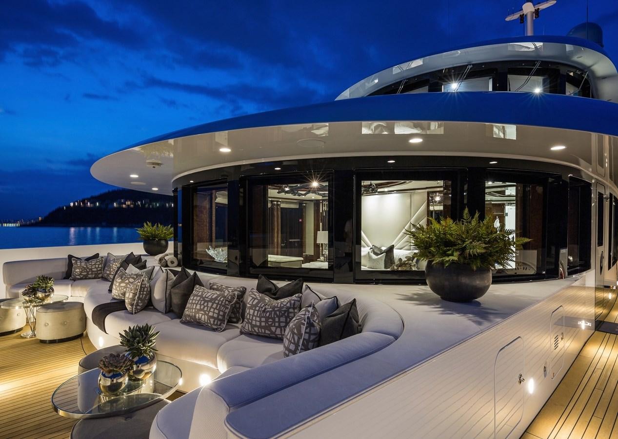 a large living room with a large patio and a large swimming pool aboard SOUNDWAVE Yacht for Sale
