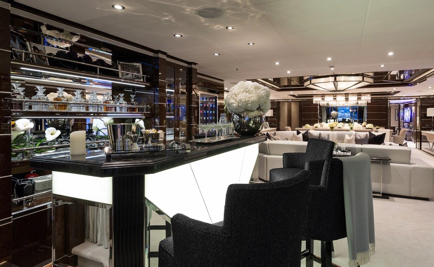 a room with a large glass display case and a black chair aboard SOUNDWAVE Yacht for Sale