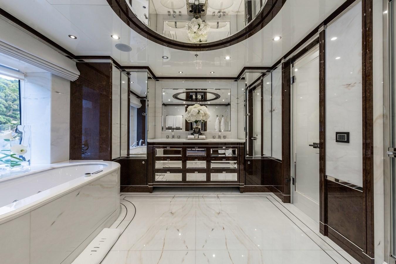 a large bathroom with a large mirror aboard SOUNDWAVE Yacht for Sale
