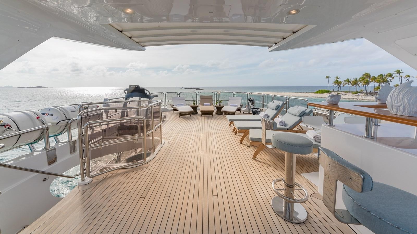 a deck with a deck and chairs on it aboard NAMASTE Yacht for Sale