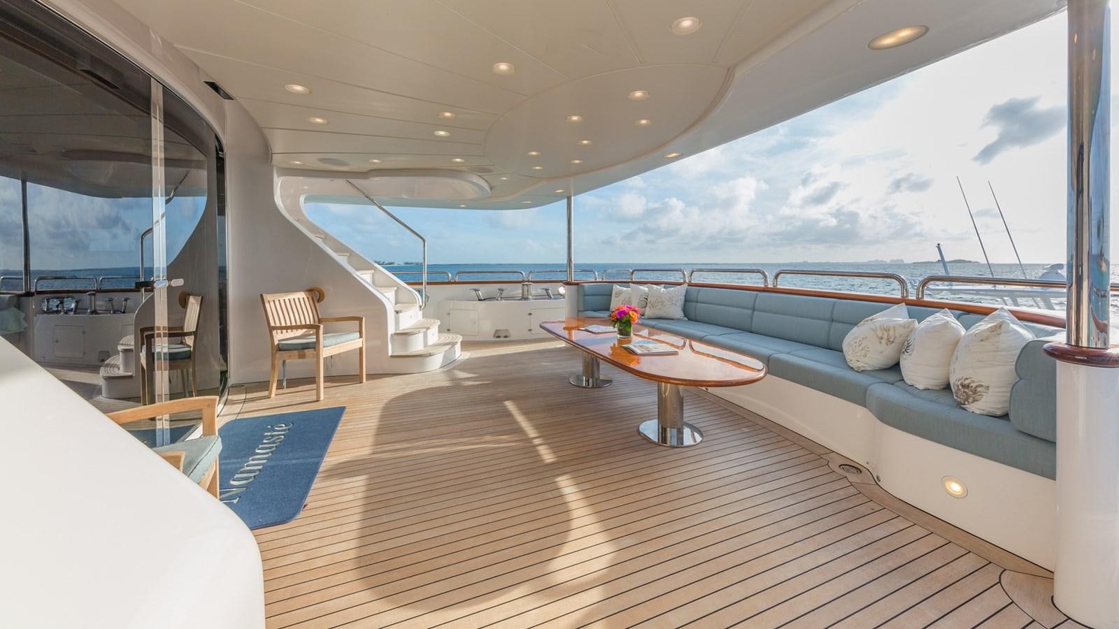 a large ship with pillows and a table and chairs aboard NAMASTE Yacht for Sale