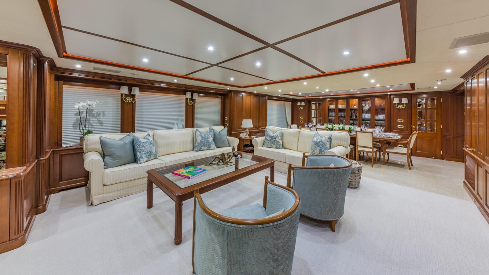 a living room with a couch and a table aboard NAMASTE Yacht for Sale