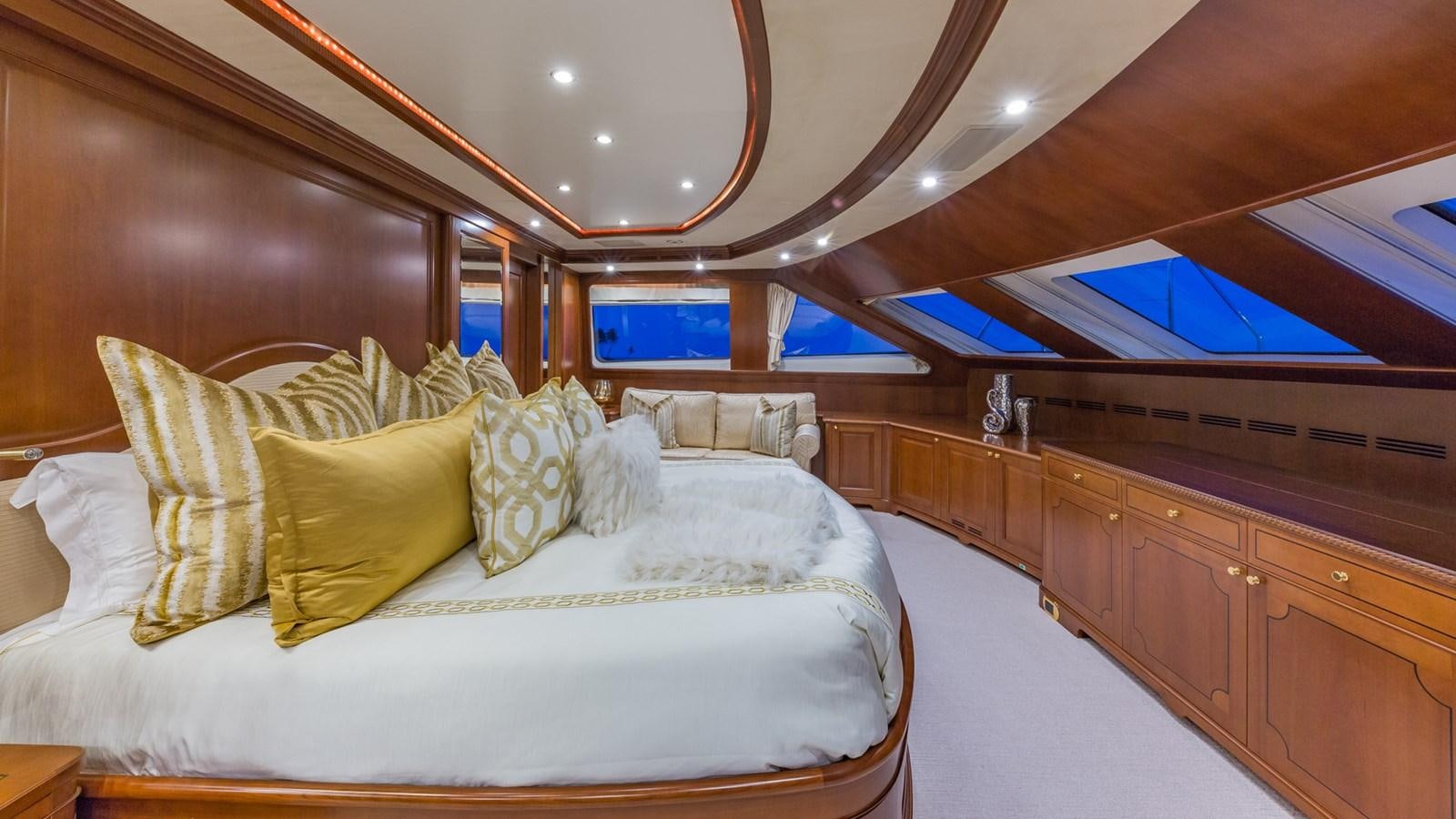 a room with a bed and a large mirror aboard NAMASTE Yacht for Sale