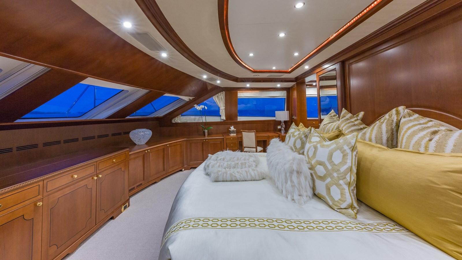 a room with a bed and a wood cabinet aboard NAMASTE Yacht for Sale