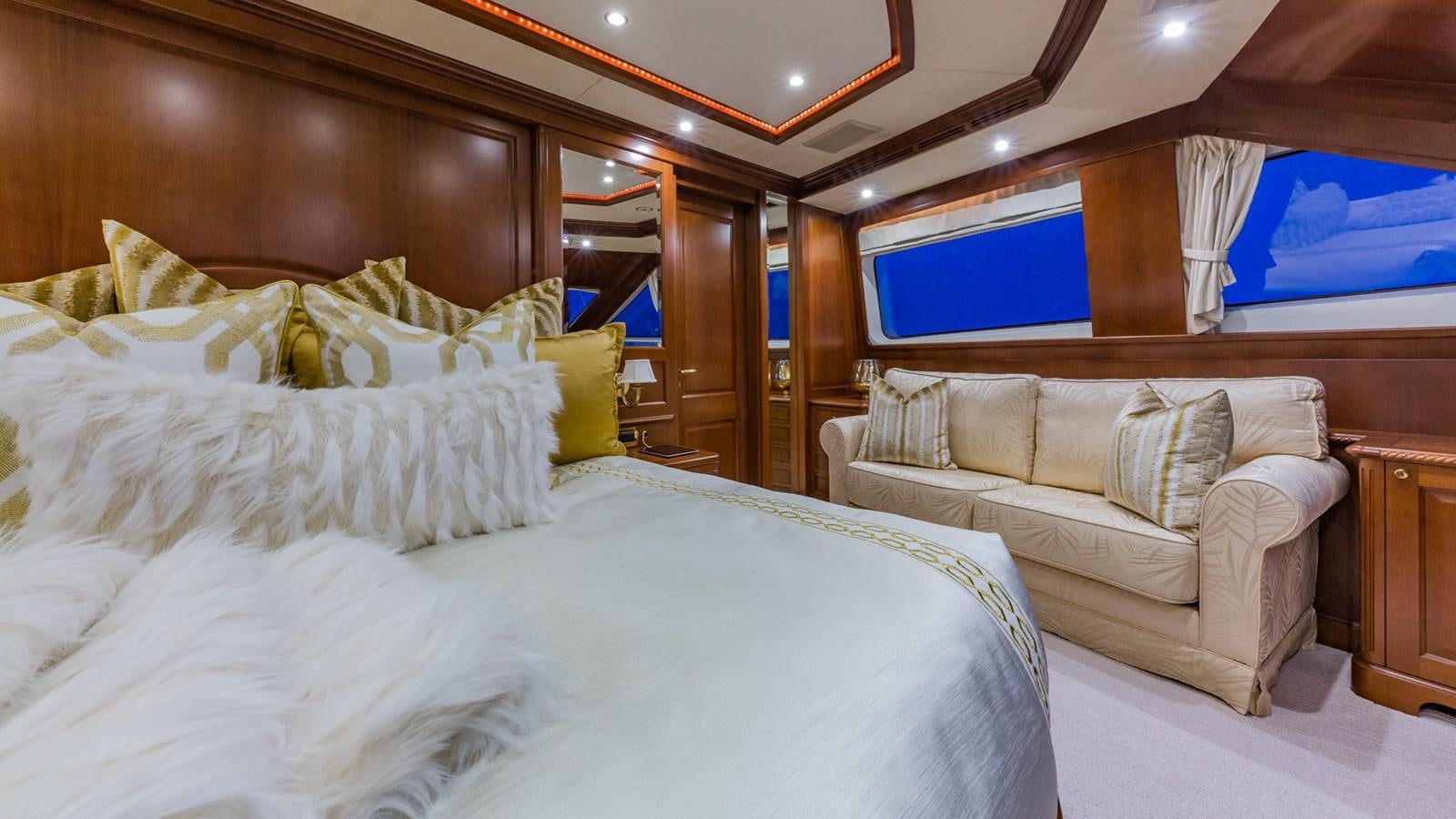 a room with a bed and a couch aboard NAMASTE Yacht for Sale