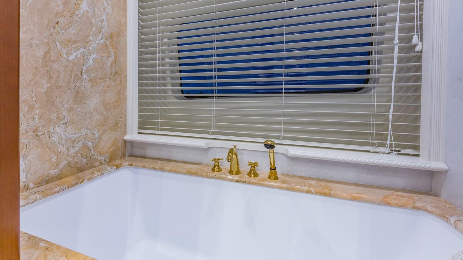 a bathtub with a window aboard NAMASTE Yacht for Sale