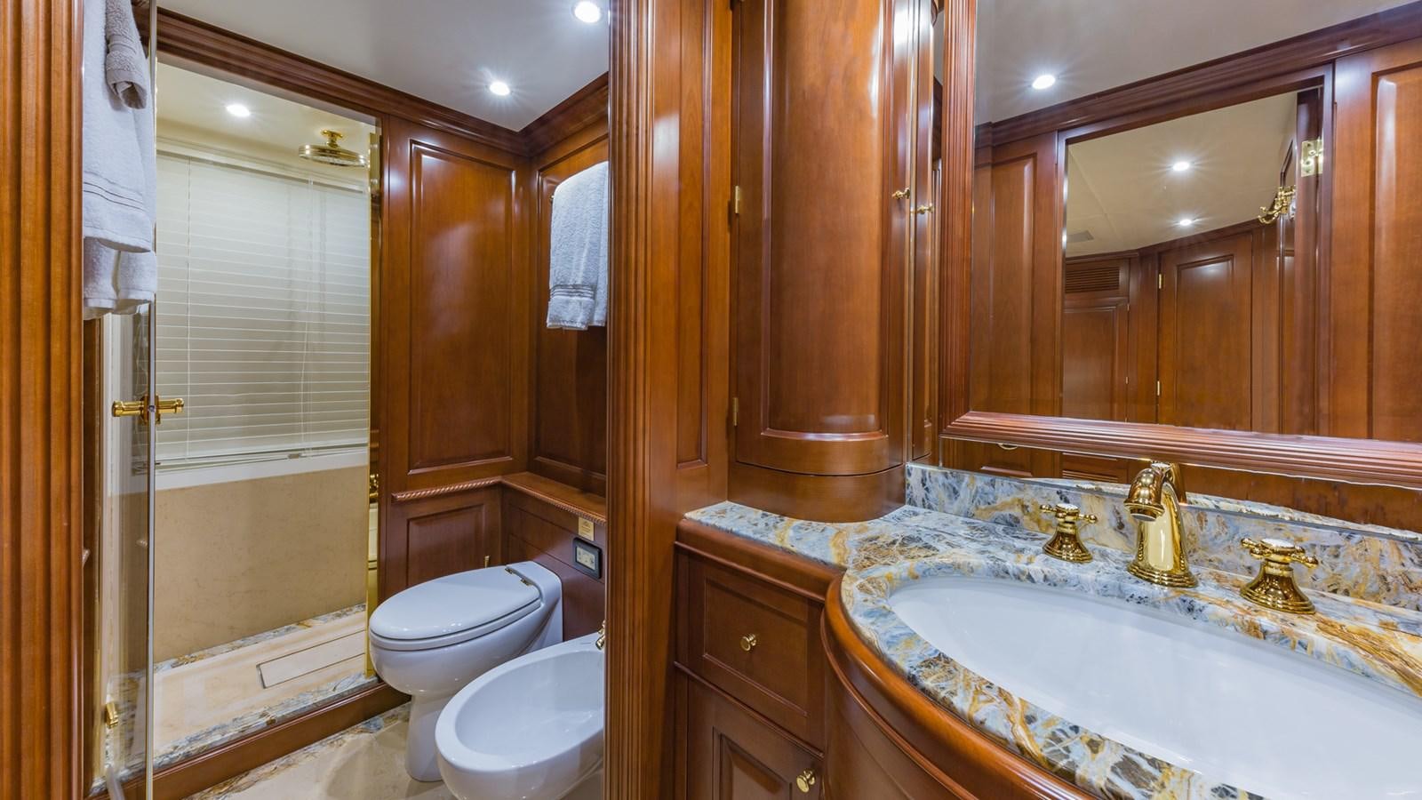 a bathroom with a large bathtub and toilet aboard NAMASTE Yacht for Sale