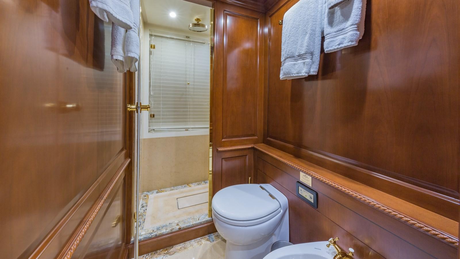 a bathroom with a toilet and a shower aboard NAMASTE Yacht for Sale