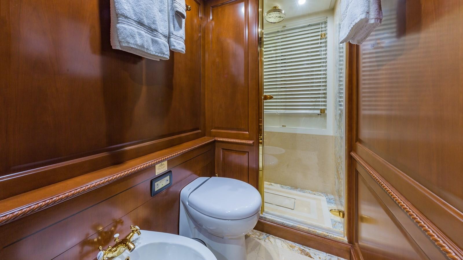 a bathroom with a toilet and a sink aboard NAMASTE Yacht for Sale
