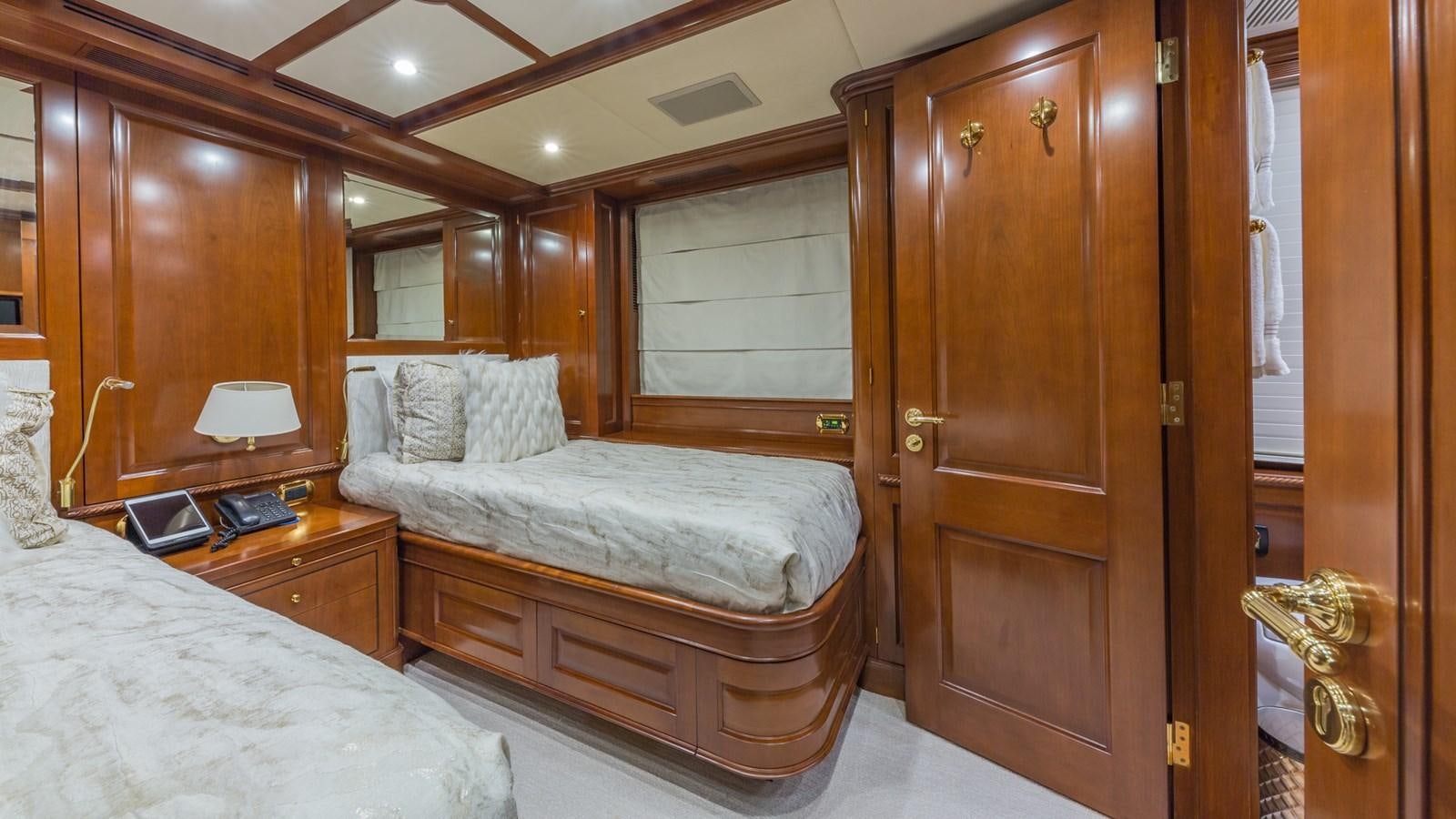 a bedroom with a bed and a closet aboard NAMASTE Yacht for Sale