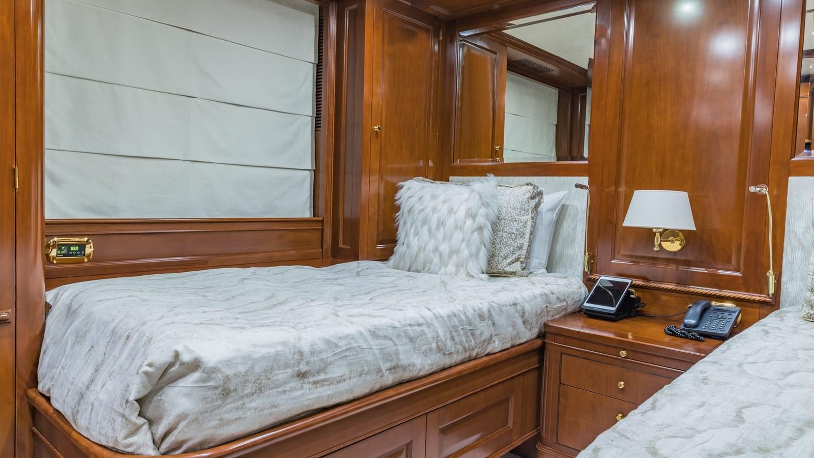 a bed with a phone on it aboard NAMASTE Yacht for Sale