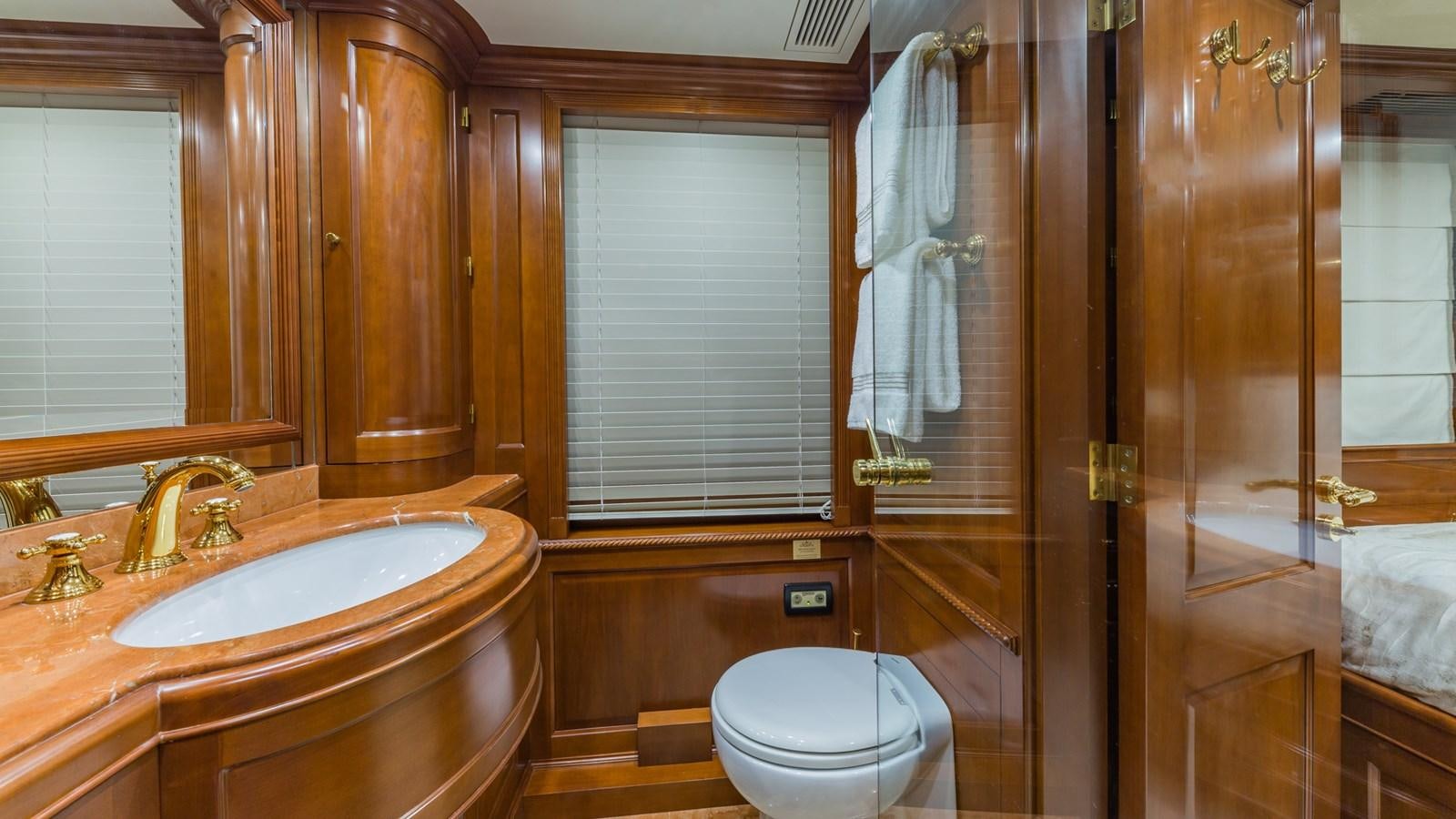 a bathroom with a sink toilet and shower aboard NAMASTE Yacht for Sale