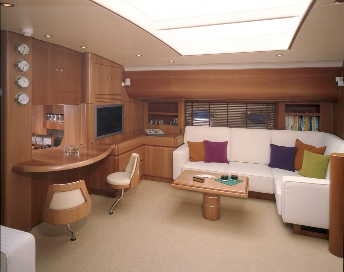 a living room with a couch and a table aboard MBOLO Yacht for Sale