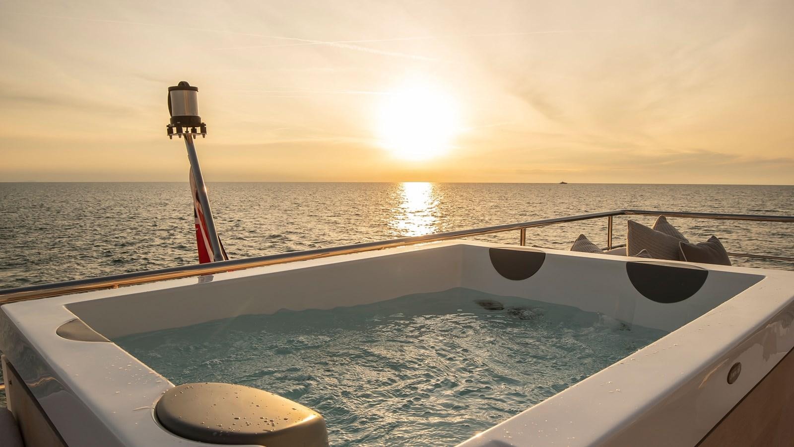 the sun setting over the ocean aboard H Yacht for Sale