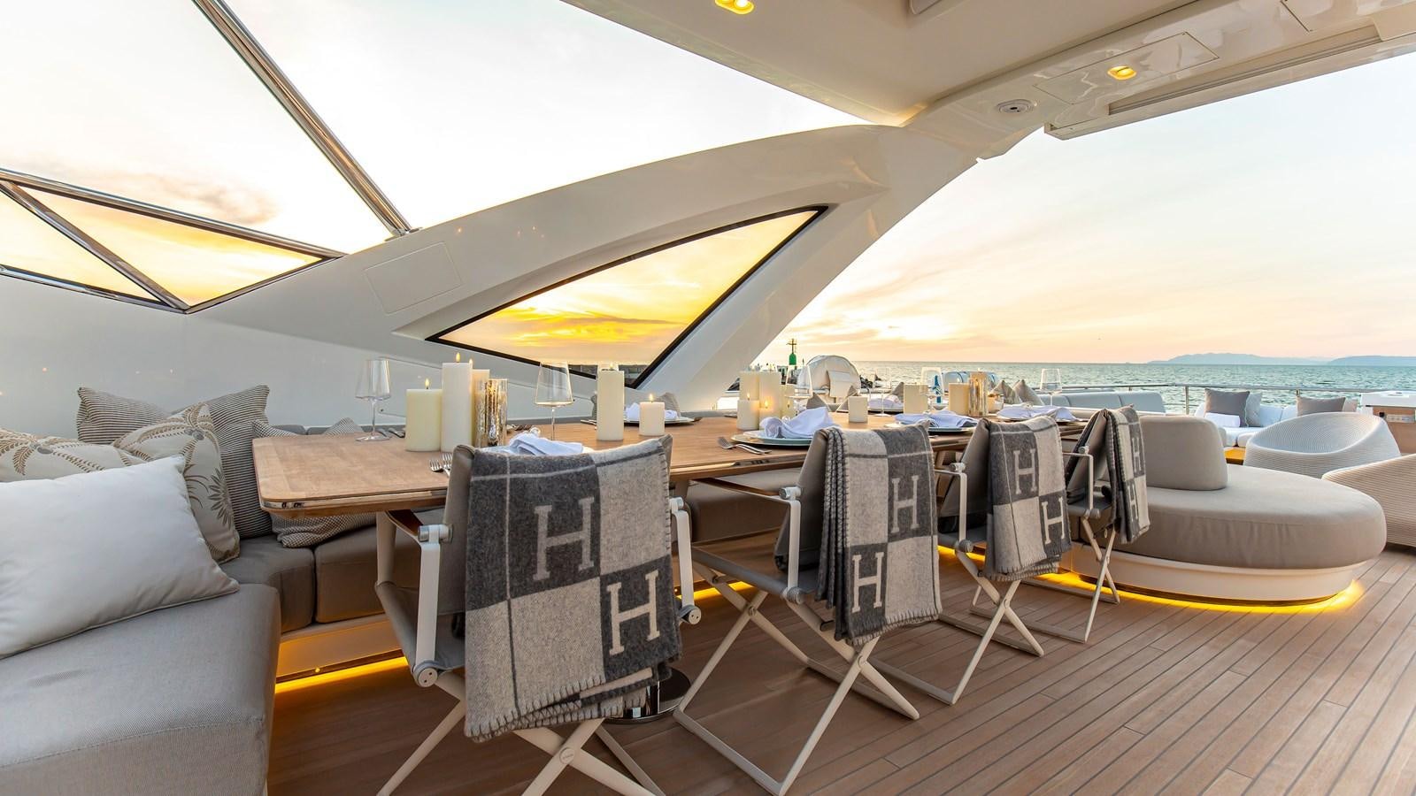 a room with a table and chairs aboard H Yacht for Sale