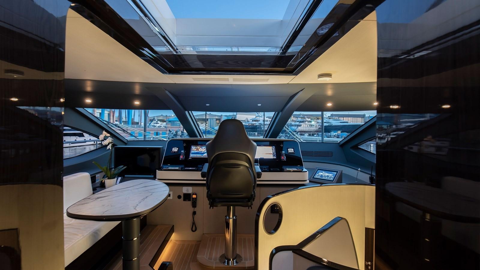 a room with a table and chairs aboard H Yacht for Sale