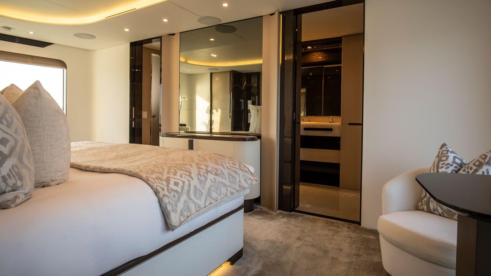a hotel room with a bed and a mirror aboard H Yacht for Sale