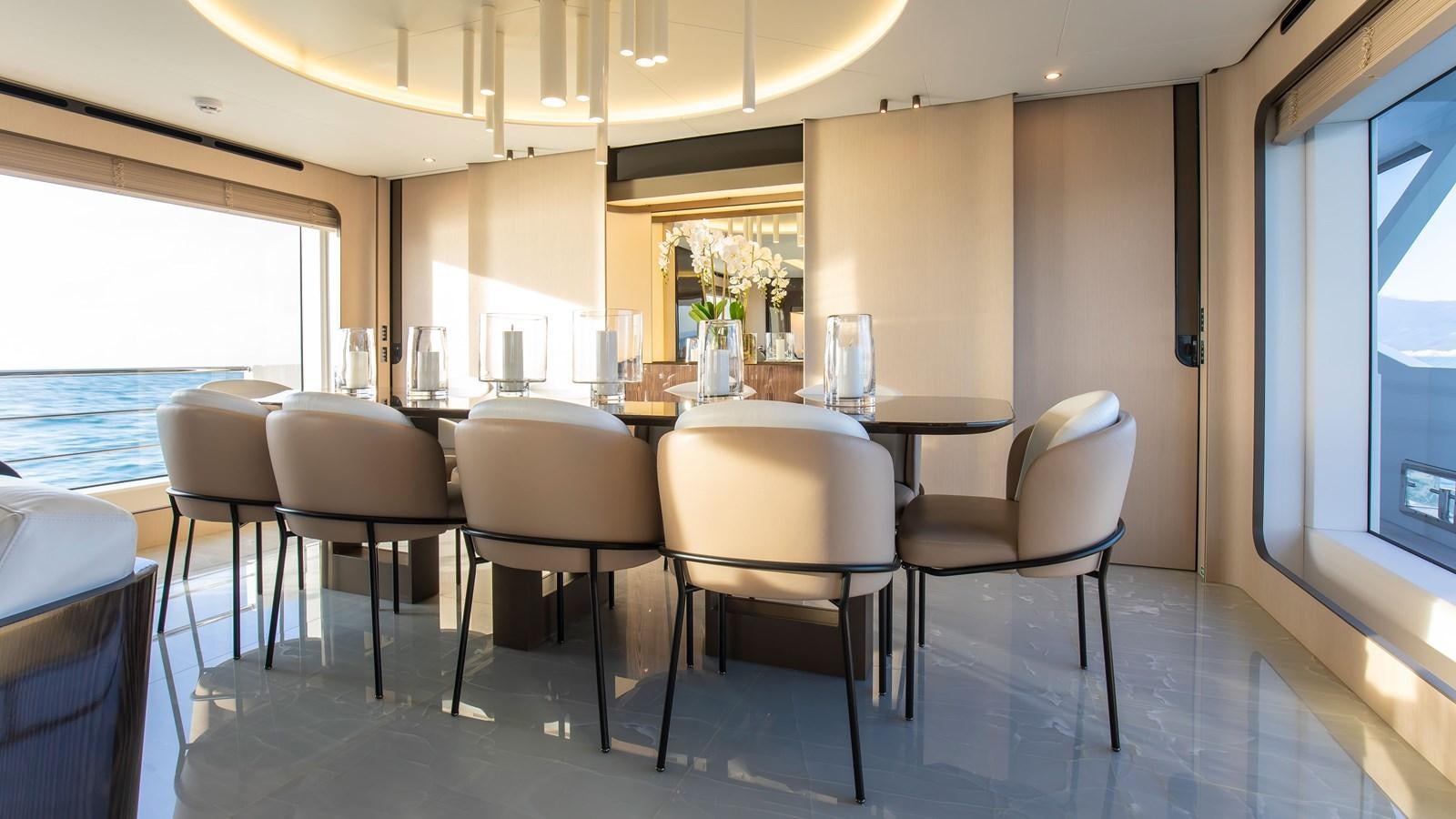 a room with a table and chairs aboard H Yacht for Sale