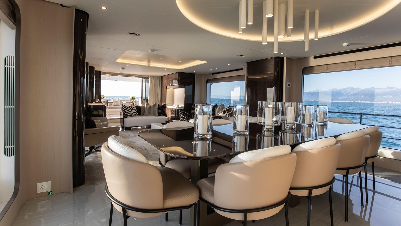 a room with a table chairs and a large window aboard H Yacht for Sale