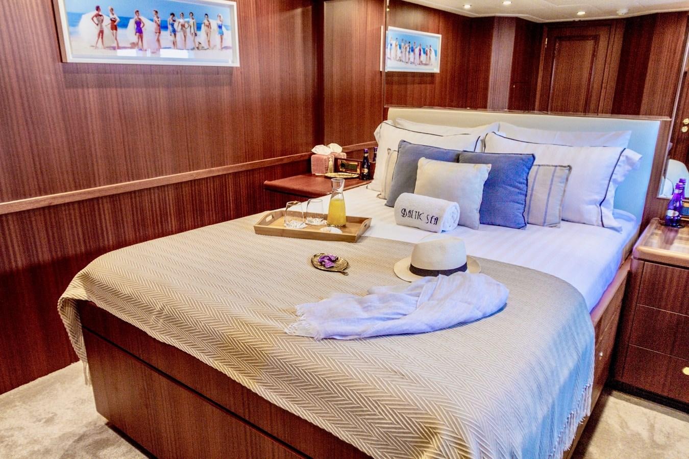 a bed with a white pillow and pillows on it aboard BALTIC SEA Yacht for Sale