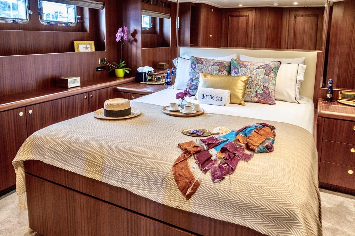 a bed with a tray of food on it aboard BALTIC SEA Yacht for Sale