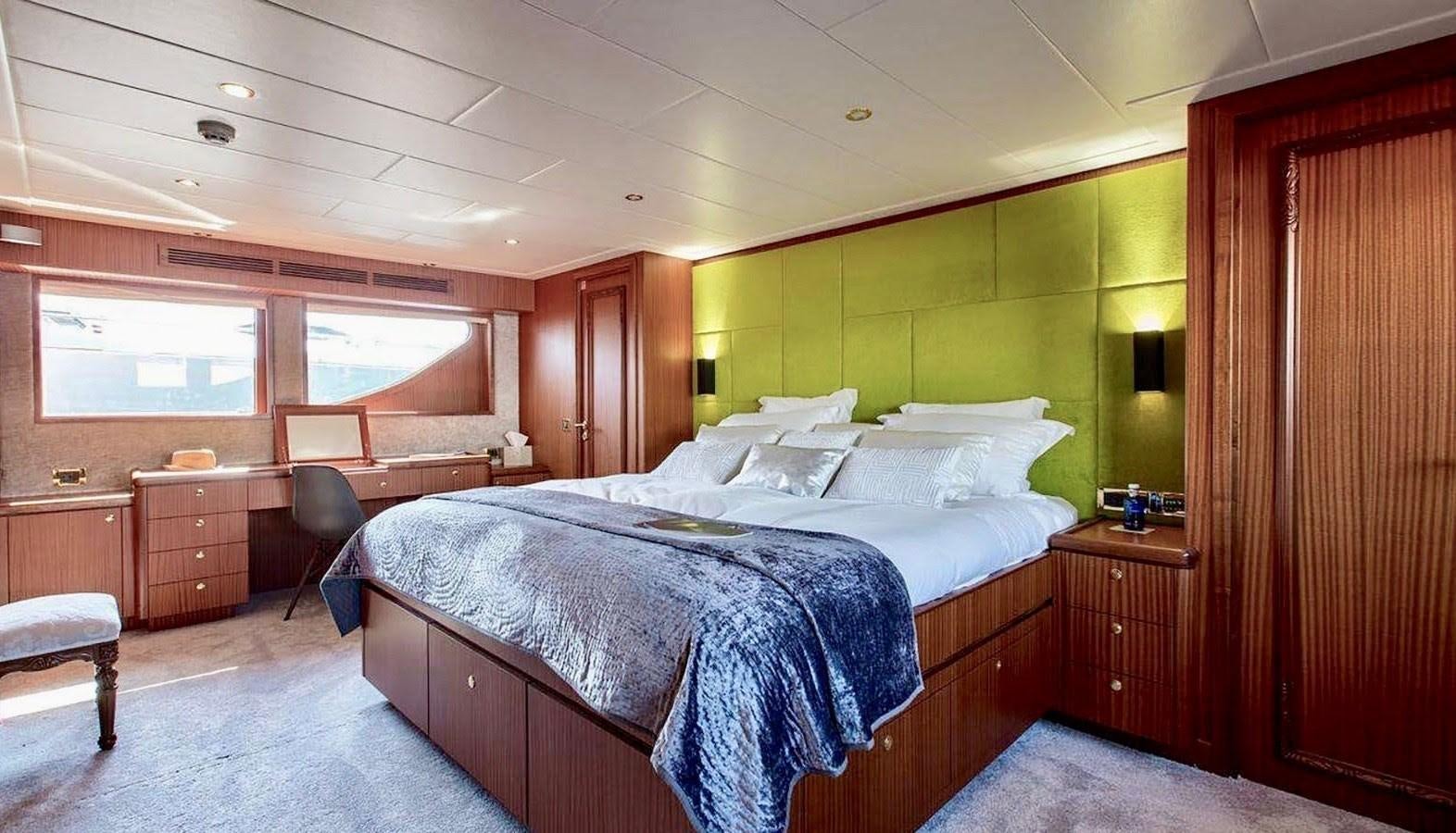 a bedroom with a bed and desk aboard BALTIC SEA Yacht for Sale