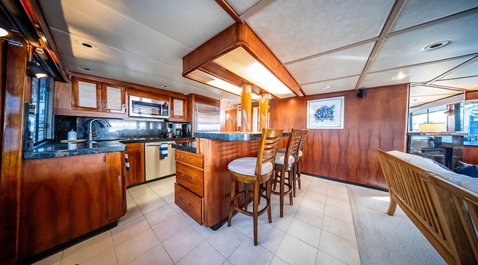 a kitchen with wooden cabinets aboard PACIFIC SHADOW Yacht for Sale
