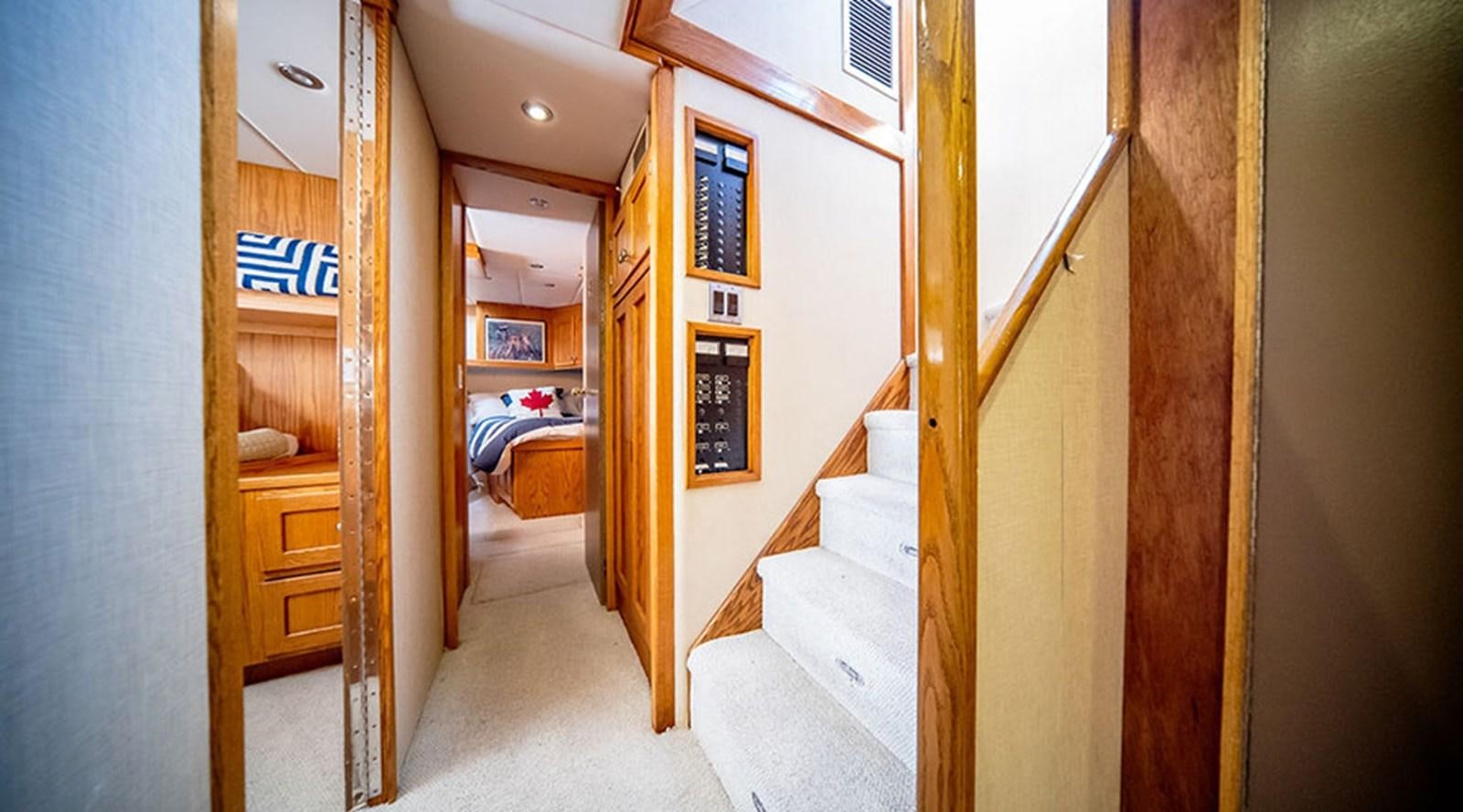 a room with a bed and a door aboard PACIFIC SHADOW Yacht for Sale