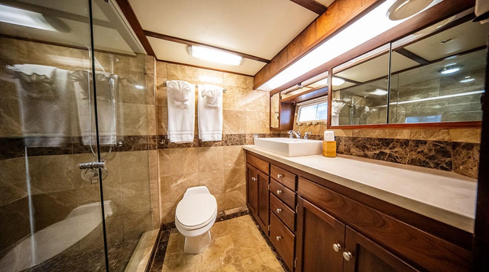 a bathroom with a glass shower aboard PACIFIC SHADOW Yacht for Sale