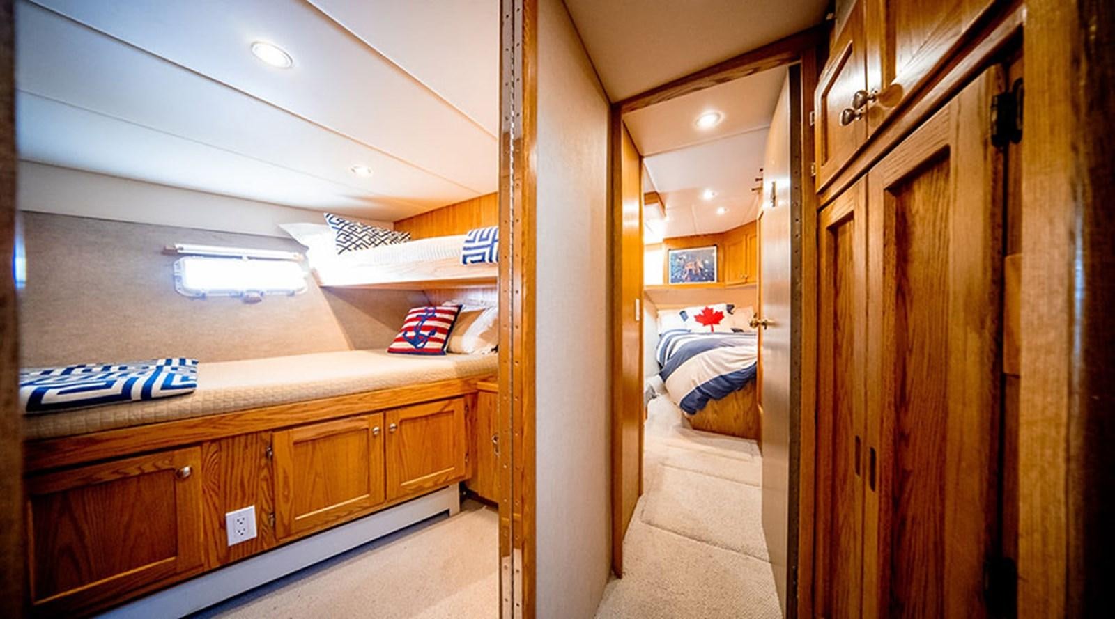 a room with a bed and a desk aboard PACIFIC SHADOW Yacht for Sale