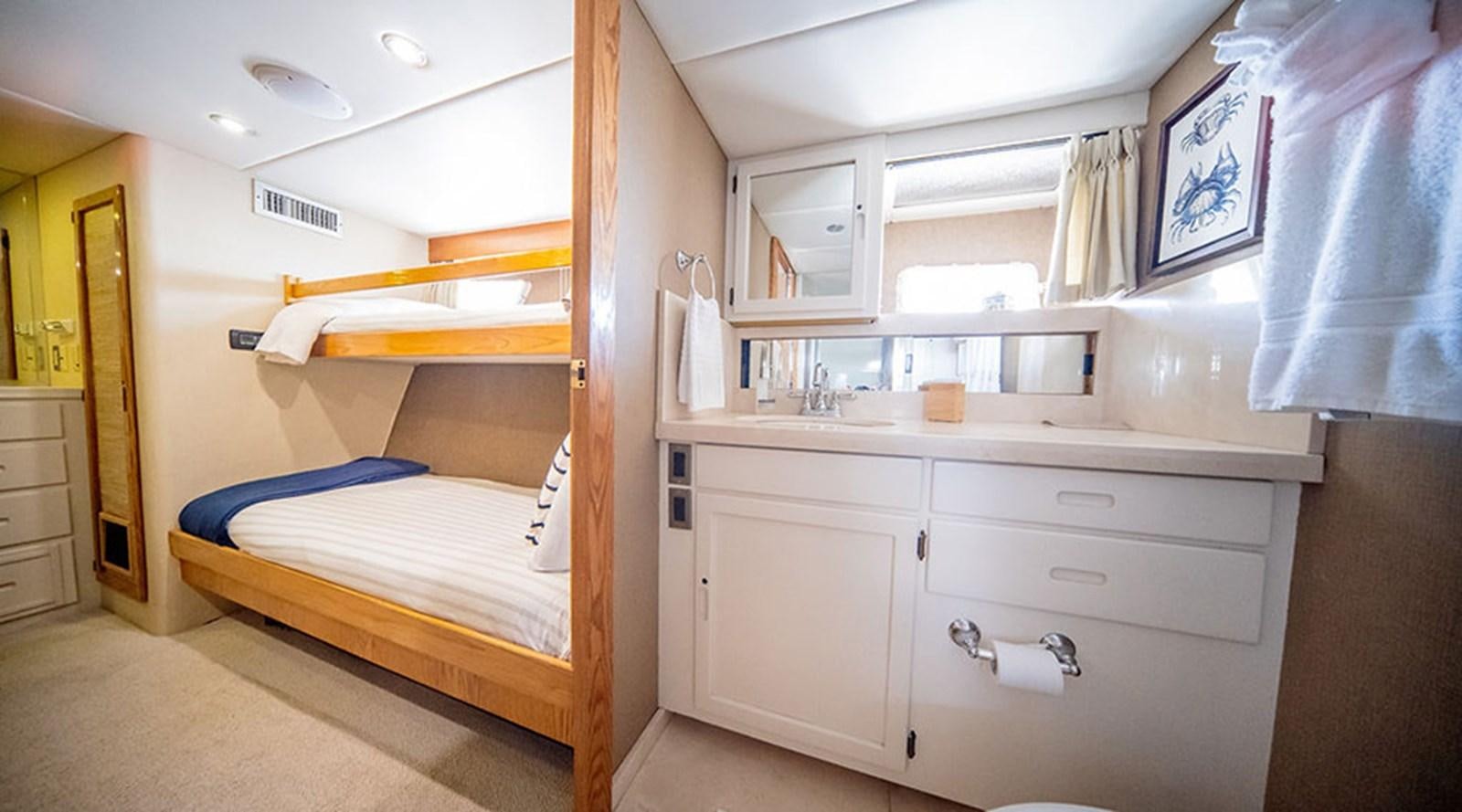 a bedroom with a bed and a desk aboard PACIFIC SHADOW Yacht for Sale