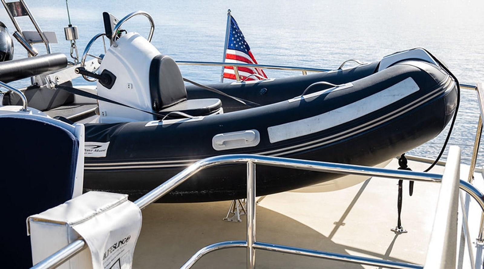 a boat with a flag on the front aboard PACIFIC SHADOW Yacht for Sale