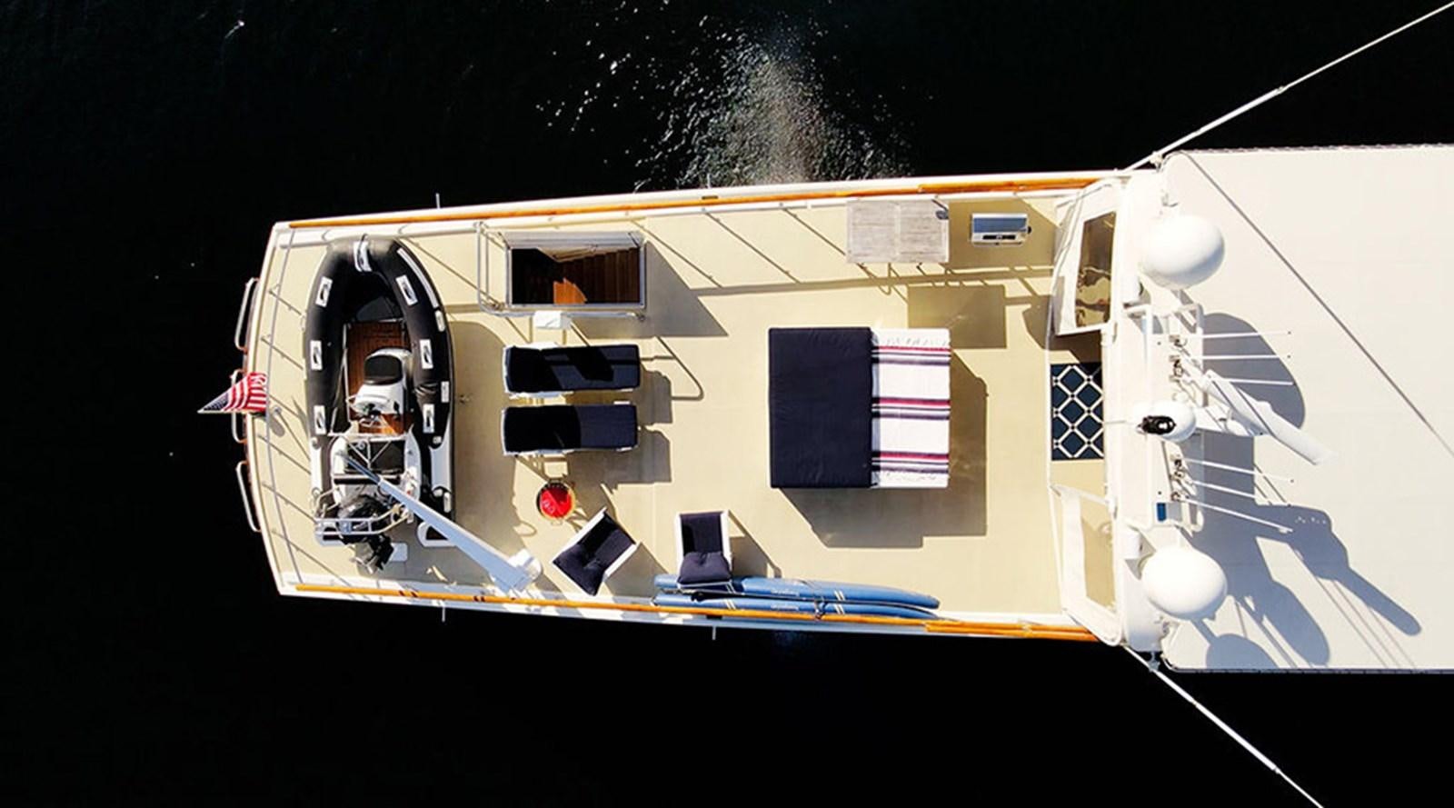 a white boat with a flag on it aboard PACIFIC SHADOW Yacht for Sale
