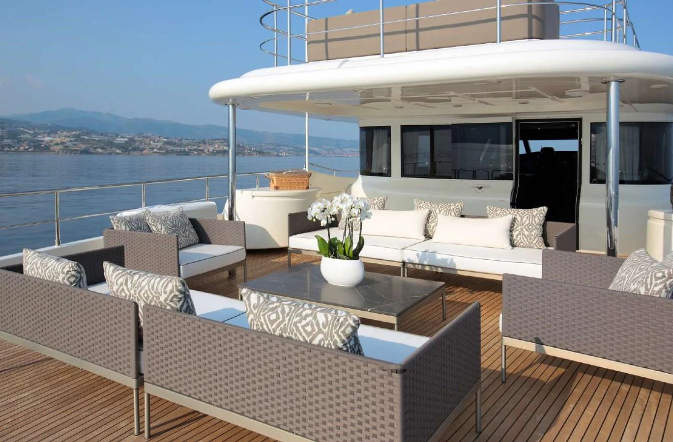 a room with couches and a table and a large body of water aboard LADY SOUL Yacht for Charter