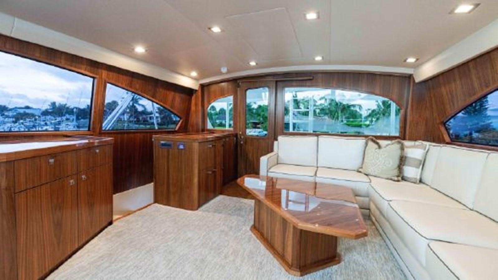 a living room with a couch and a table aboard MAKARA Yacht for Sale