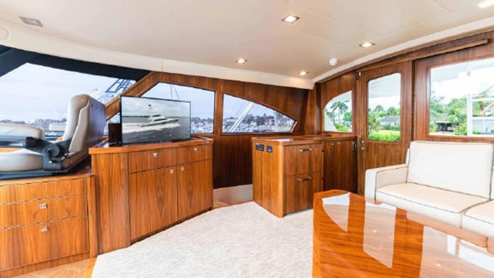 a living room with a couch and a television aboard MAKARA Yacht for Sale