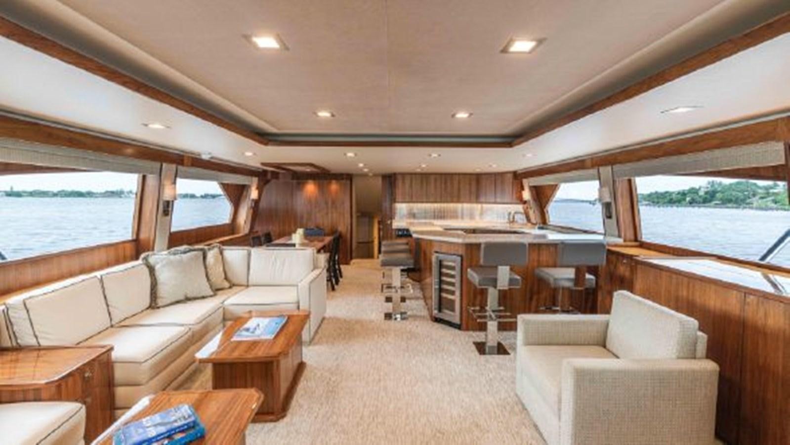 a living room with a couch and a table aboard MAKARA Yacht for Sale