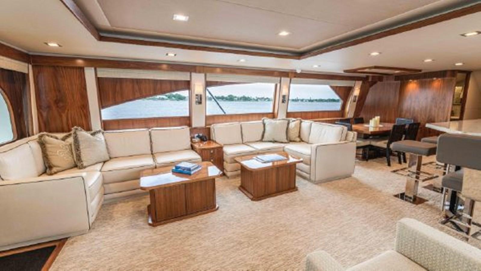 a living room with a couch and a table aboard MAKARA Yacht for Sale