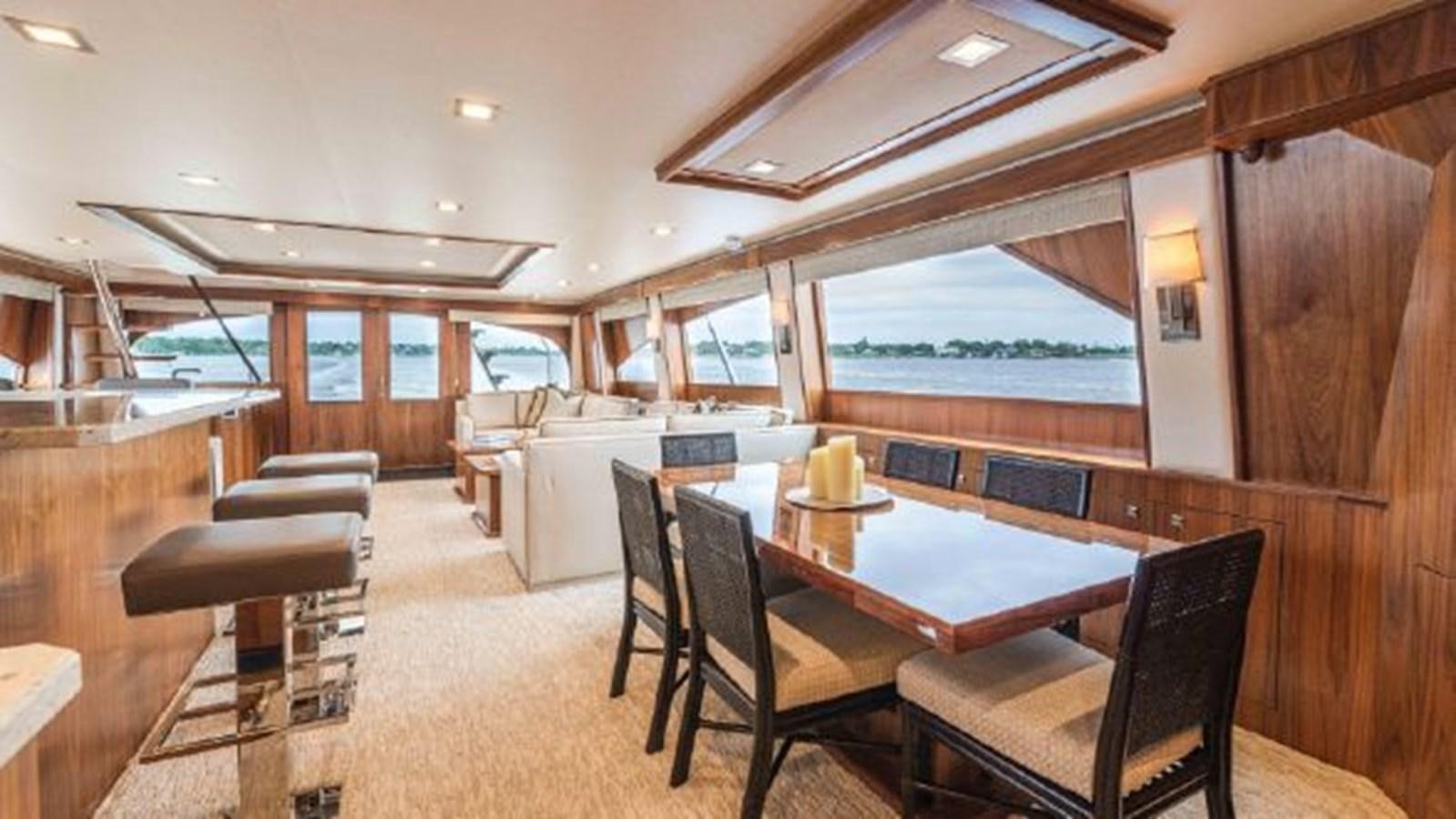 a room with a table chairs and a large window aboard MAKARA Yacht for Sale