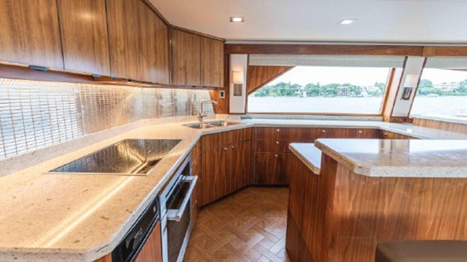 a kitchen with wooden cabinets aboard MAKARA Yacht for Sale